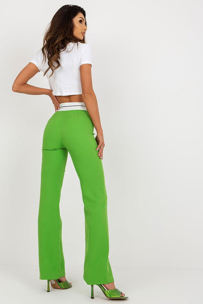 Rear view of high-waisted green trousers by Italy Moda, showcasing a contemporary design, paired with a stylish white top.