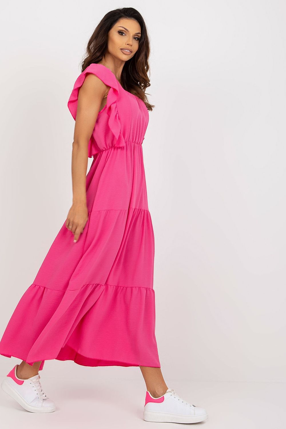 Side profile of a striking pink summer dress by Italy Moda, featuring a flowing design and elegant ruffles, ideal for summer soirées.