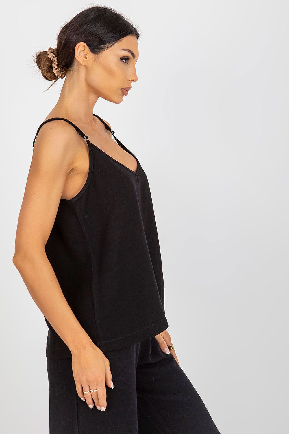 Side profile of a black adjustable strap V-neck shirt by Och Bella, showcasing a refined casual outfit.
