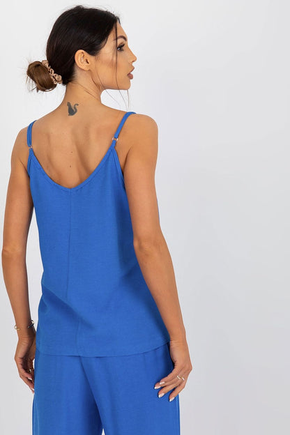 Back view of the Och Bella blue loose-fitting v-neck shirt, highlighting the adjustable straps and stylish design modeled elegantly.