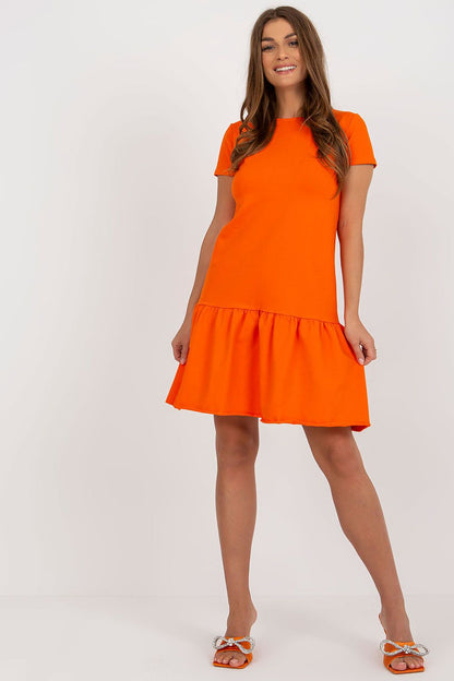 Elegant orange summer dress with frill hem, model wearing Rue Paris design, perfect for casual outings.