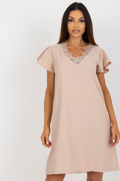 Sophisticated model showcasing an elegant loose-fitting daydress by Rue Paris, featuring ruffle sleeves and intricate lace detailing at the neckline, perfect for versatile occasions.