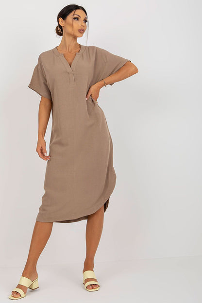 Stylish Och Bella shirt dress featuring a heart neckline and side slit, crafted from a luxurious cotton, linen, and viscose blend. Model poses elegantly, showcasing the chic design.