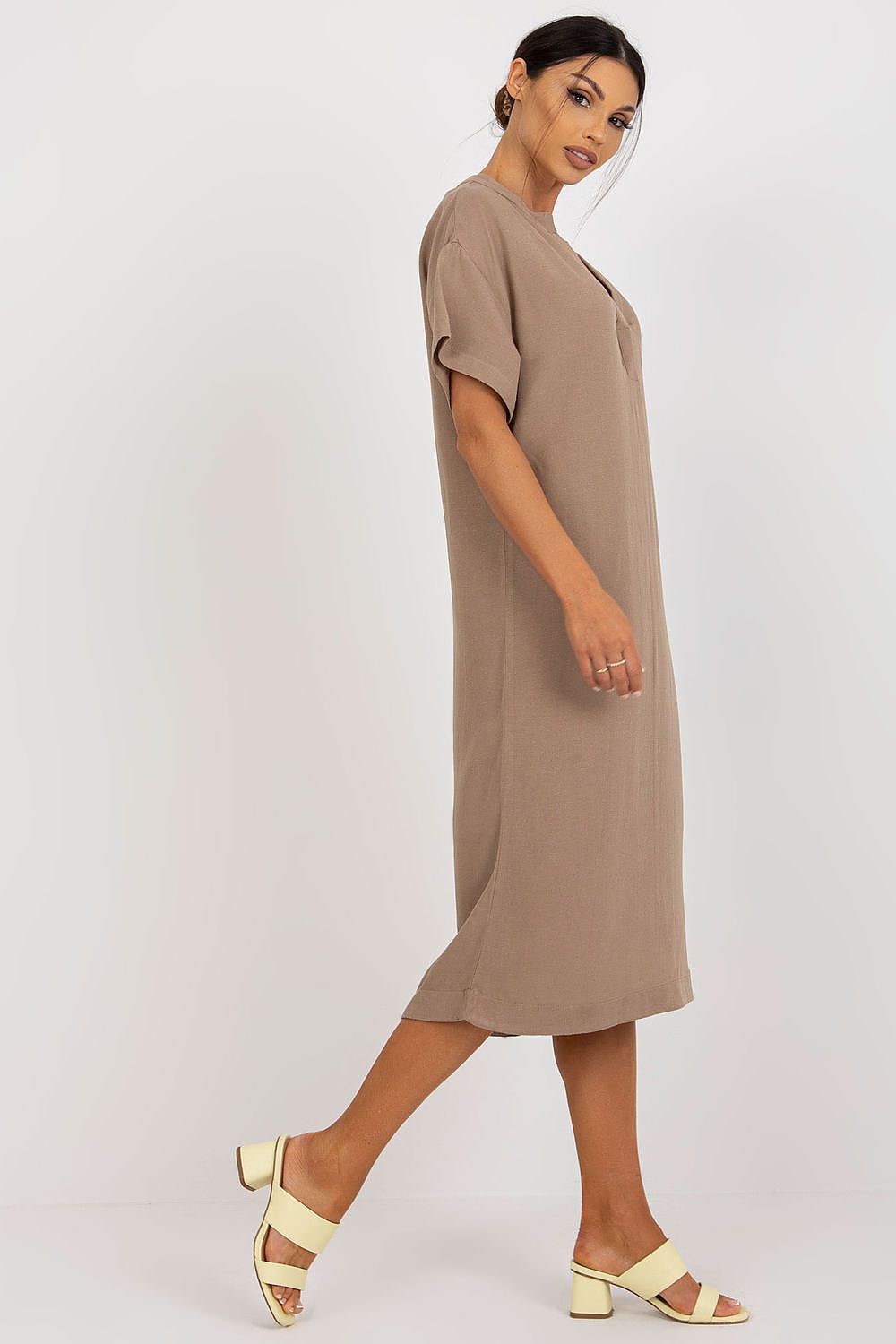 Side profile of a sophisticated Och Bella shirt dress with a heart neckline, made from a premium cotton, linen, and viscose blend. The model displays the dress's flattering silhouette.