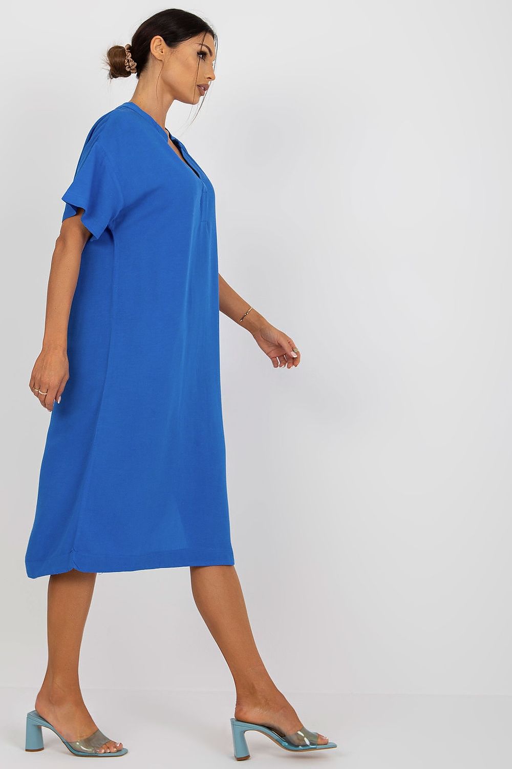 Profile view of an elegant blue Och Bella shirt dress with a heart neckline and side slit, made from high-quality cotton, linen, and viscose blend, perfect for any occasion.