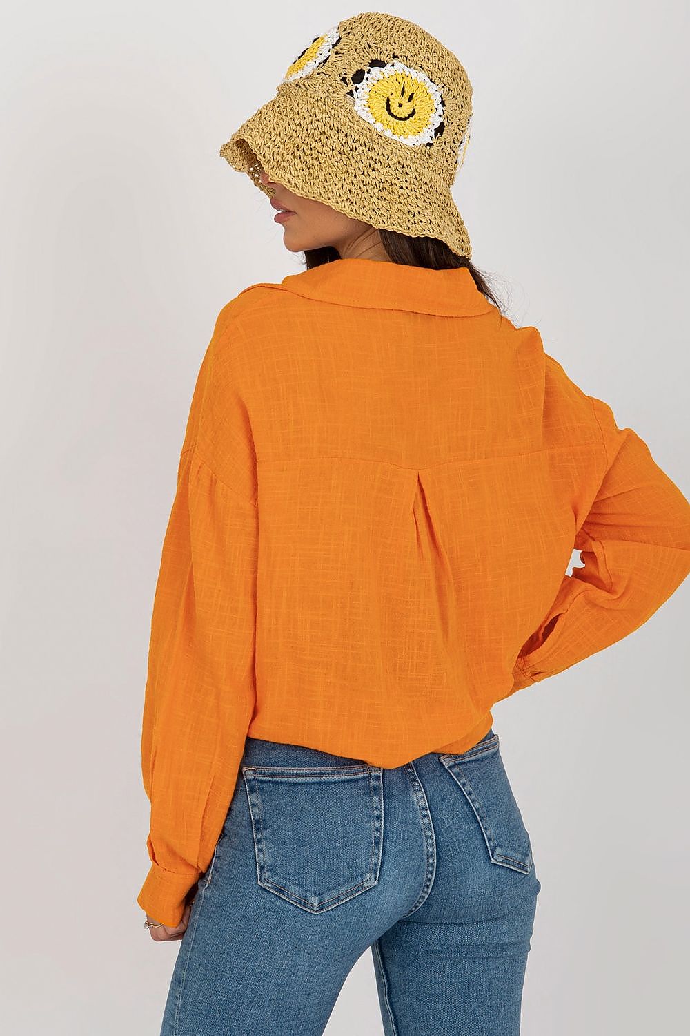 Elegant Och Bella Cotton Long Sleeve Shirt in vibrant orange, showcasing a loose fit with a button front, styled with a playful straw hat in a delightful smiley design.