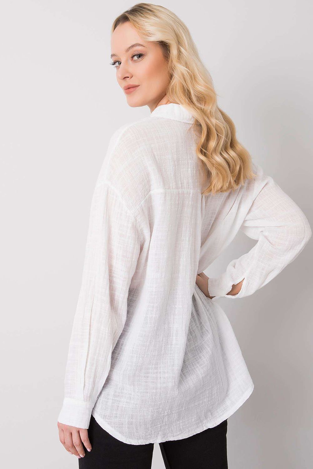 Refined back view of the Och Bella Cotton Long Sleeve Shirt in white, capturing the relaxed elegance and soft texture, paired with chic trousers.