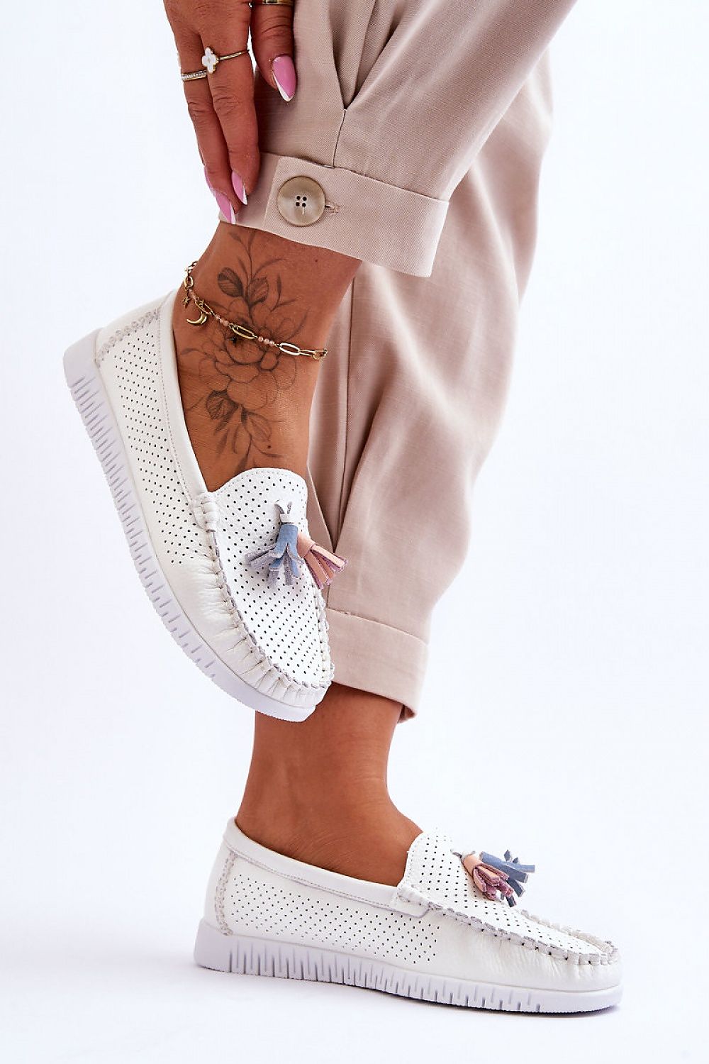 Luxury women's moccasin flats by Step in Style, crafted from natural leather with elegant decorative tassels and featuring a non-slip sole.