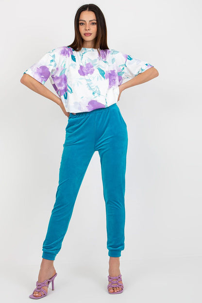 Chic short sleeve blouse and high-waisted pants set by Rue Paris, an embodiment of contemporary luxury and comfort.