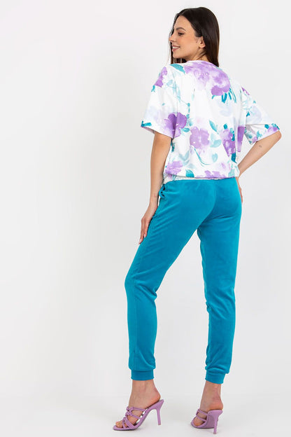 Model wearing the luxurious velour blouse and high-waisted pants set by Rue Paris, showcasing a perfect blend of comfort and style.