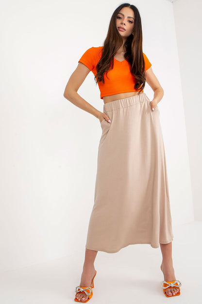 Model wearing a luxurious long skirt by Rue Paris in visose blend, showcasing a stylish summer outfit ideal for warm weather occasions.