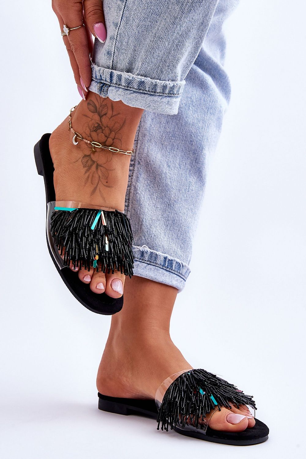 Chic flat-heeled flip-flops adorned with colorful beads and tassels, perfect for summer outings, by Step in Style.