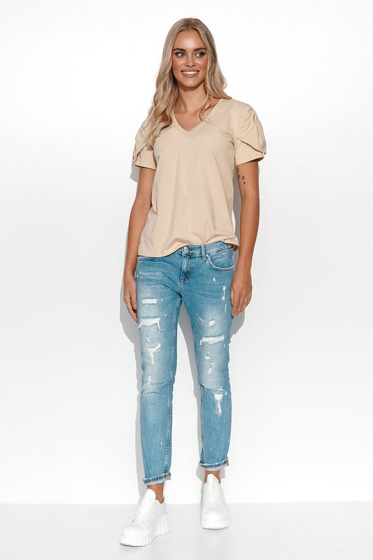 Close-up view of the Makadamia women's blouse, highlighting the intricate heart neckline and gold plate detail, perfect for sophisticated and modern attire.