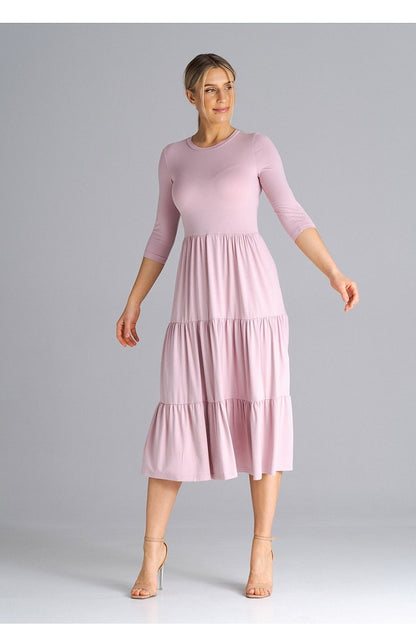Classic and stylish Figl dress with a fitted waist and luxurious ruffled details, ideal for modern elegance.
