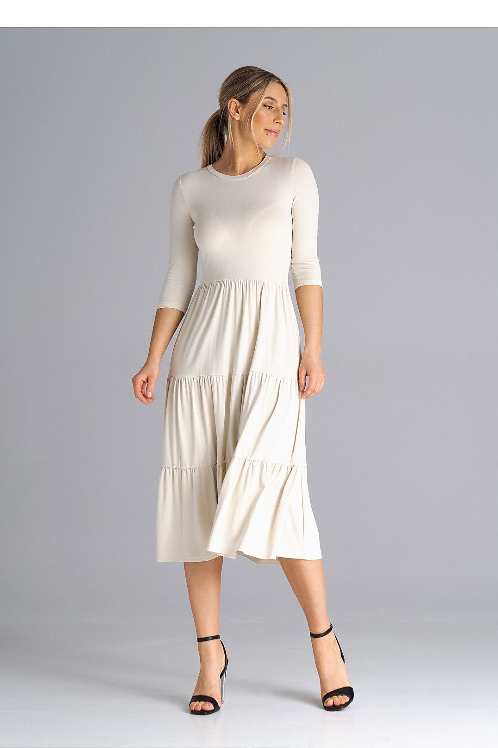 Model elegantly displaying Figl Midi Dress featuring chic 3/4 sleeves, ideal for formal and casual events.