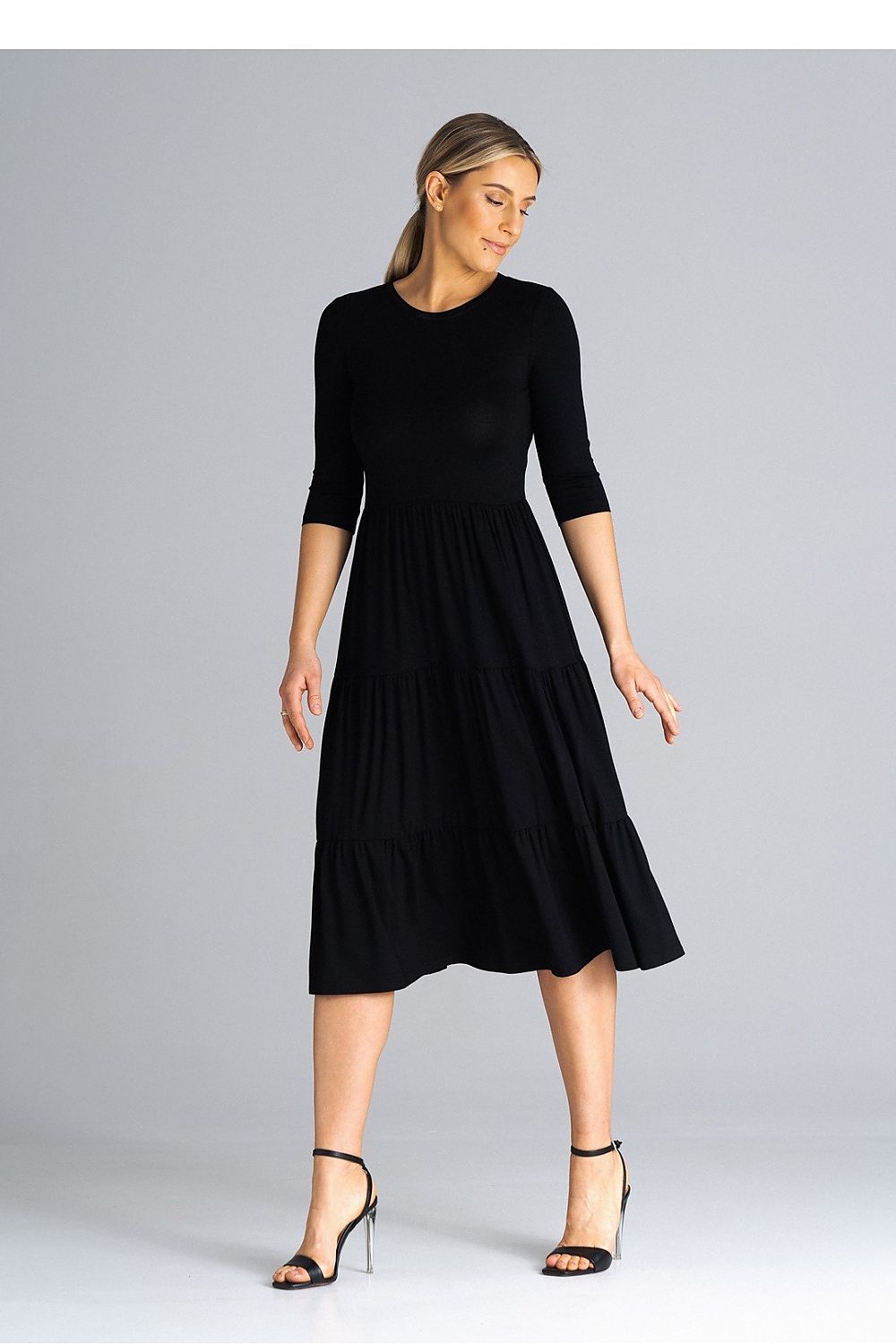 Graceful Figl midi dress with fitted waist and flowing layers of crinkled ruffles, embodying timeless elegance.