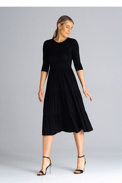 Graceful Figl midi dress with fitted waist and flowing layers of crinkled ruffles, embodying timeless elegance.