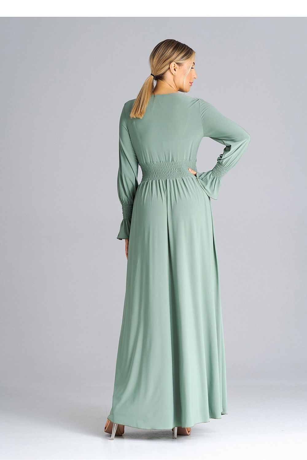 Stylish side view of Figl Elegant Maxi Dress, highlighting the waist crinkle and alluring leg slit for added elegance.