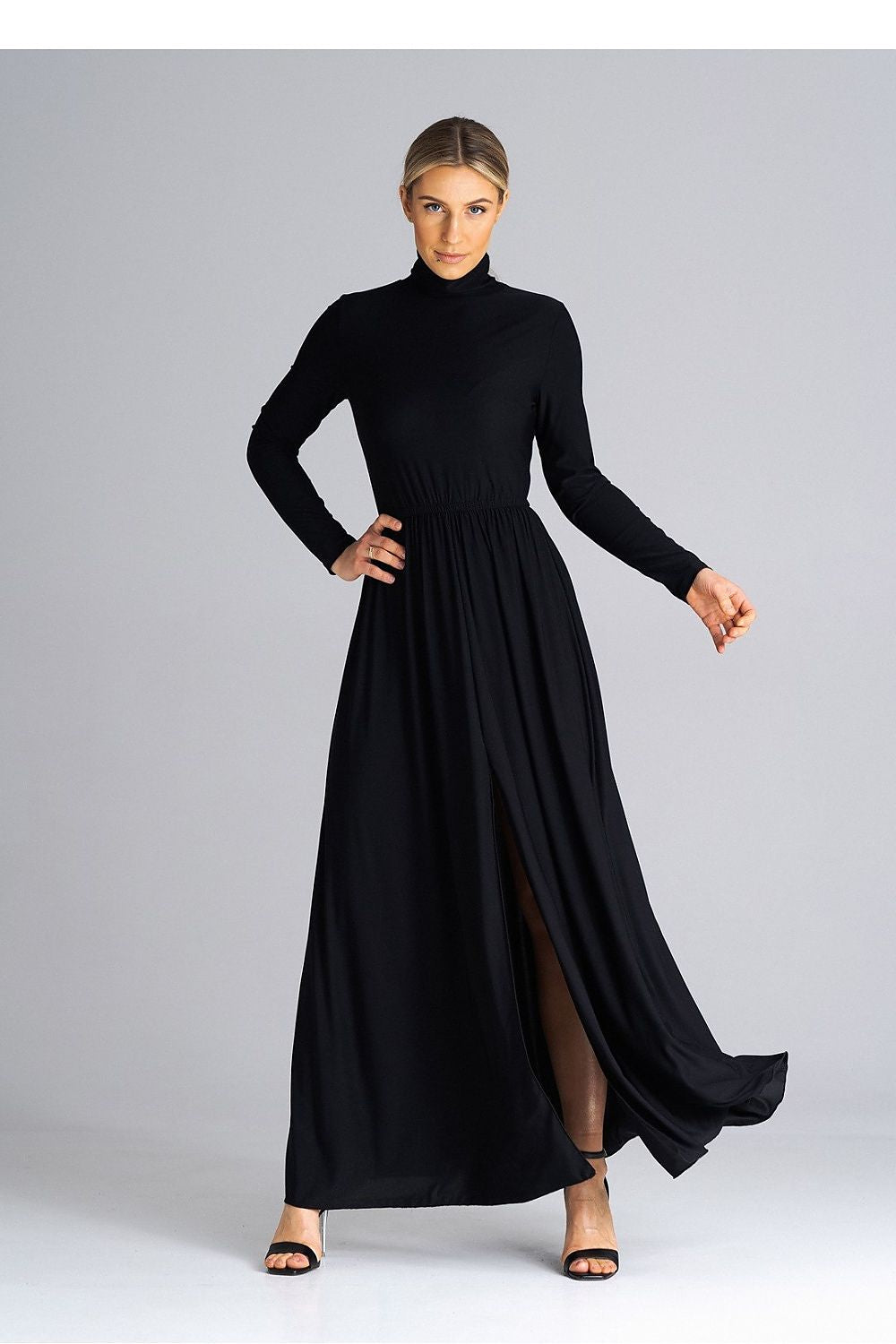 Model wearing Figl maxi dress with turtleneck and flared hem, exemplifying luxury and style for formal events.