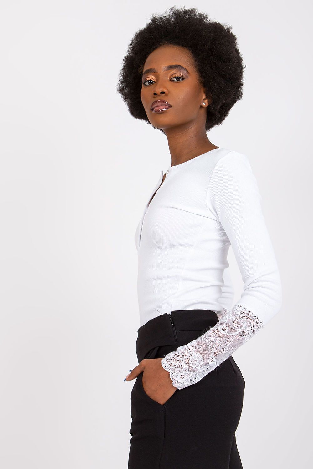 Close-up of the ribbed texture and intricate lace detail on the elegant blouse by Rue Paris, highlighting the sensual craftsmanship.
