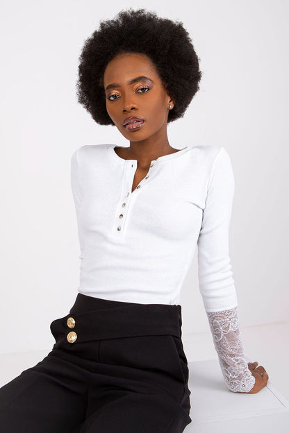 Ribbed blouse displayed on a model, styled with chic accessories, exemplifying the versatile fashion by Rue Paris for daily or evening wear.