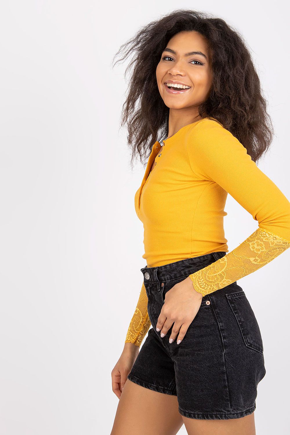 Fashion model wearing a Rue Paris ribbed blouse, demonstrating versatility from daily wear to stylish evening looks.