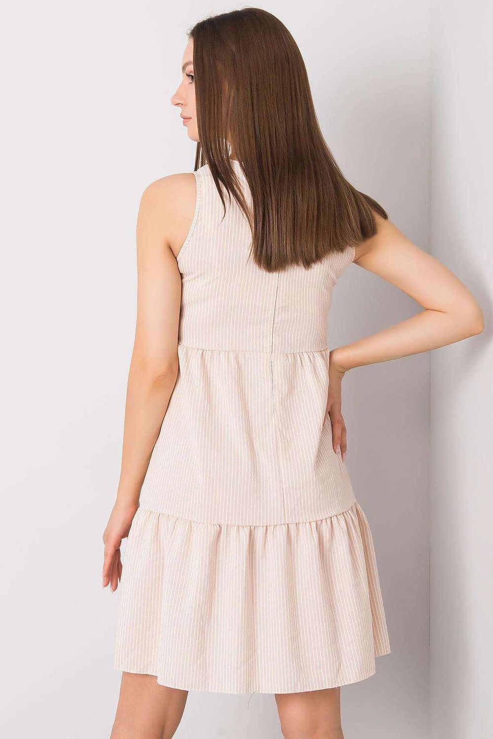 Close-up view of the ruffle hem detail on the elegant beige cotton daydress by Rue Paris, emphasizing its sophisticated style.