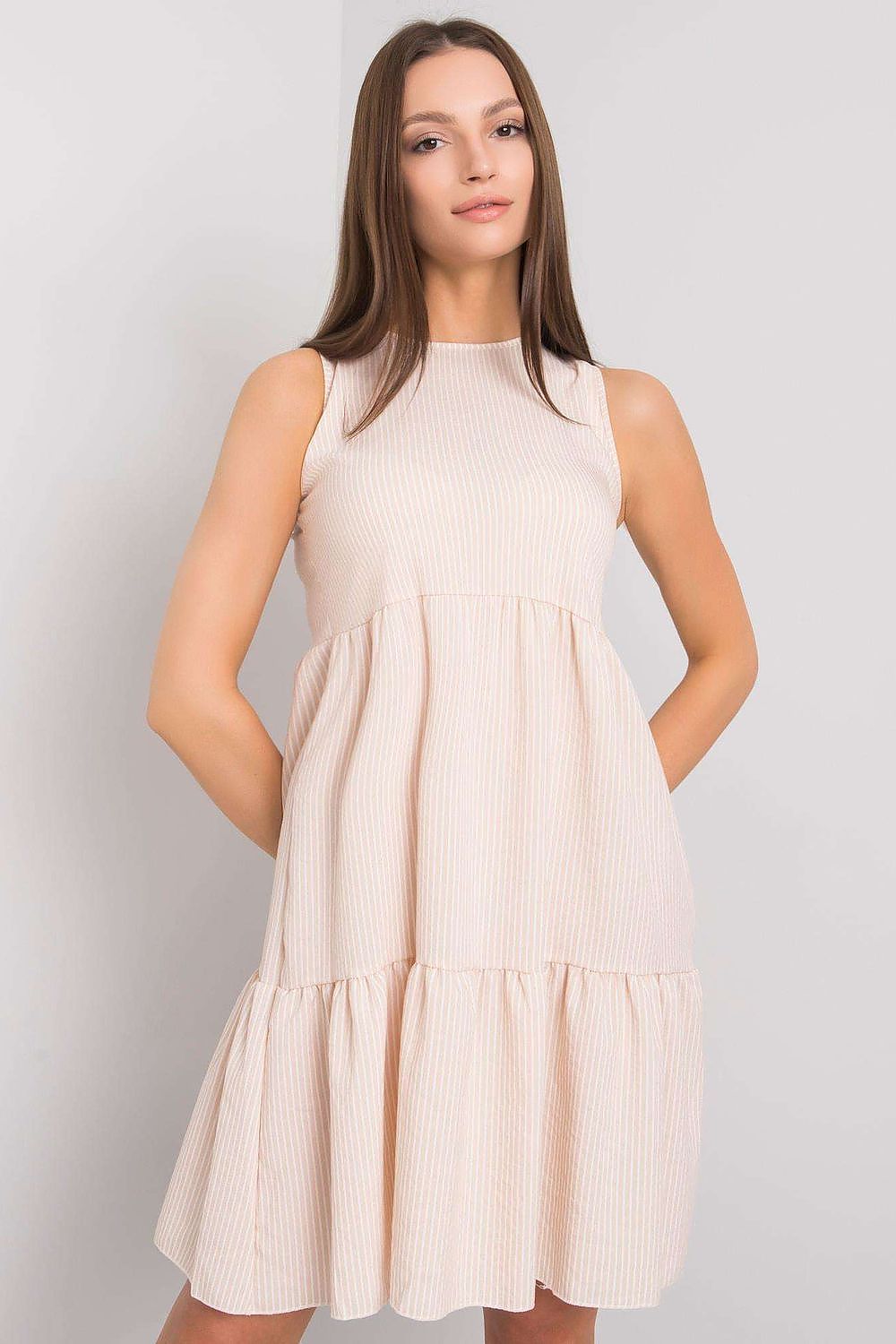 Model wearing the elegant beige cotton daydress with covered zipper by Rue Paris, perfect for a chic summer outing.
