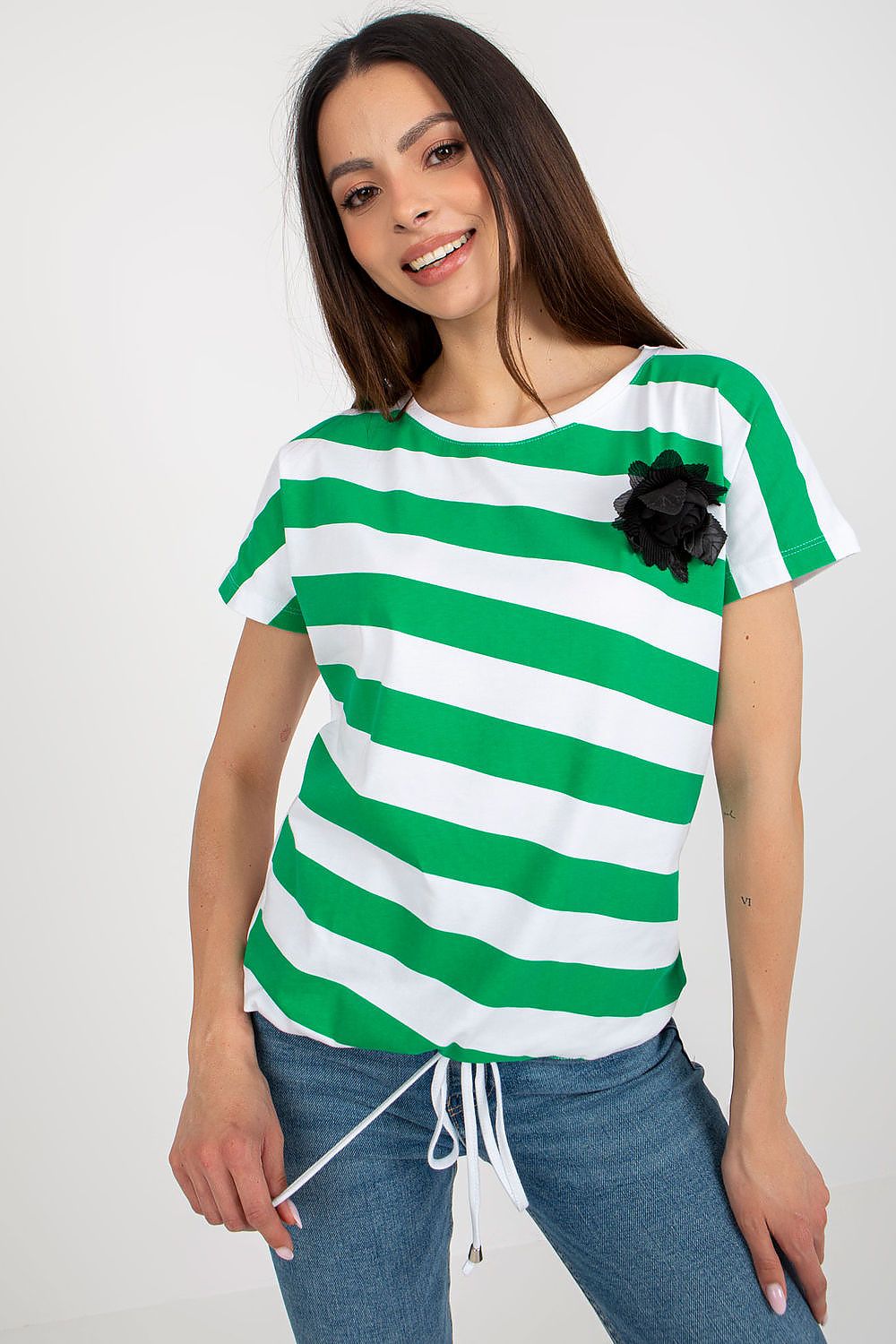 Chic women's blouse featuring short sleeves and a round neckline, highlighted by a floral brooch and colourful patterns, from Relevance.