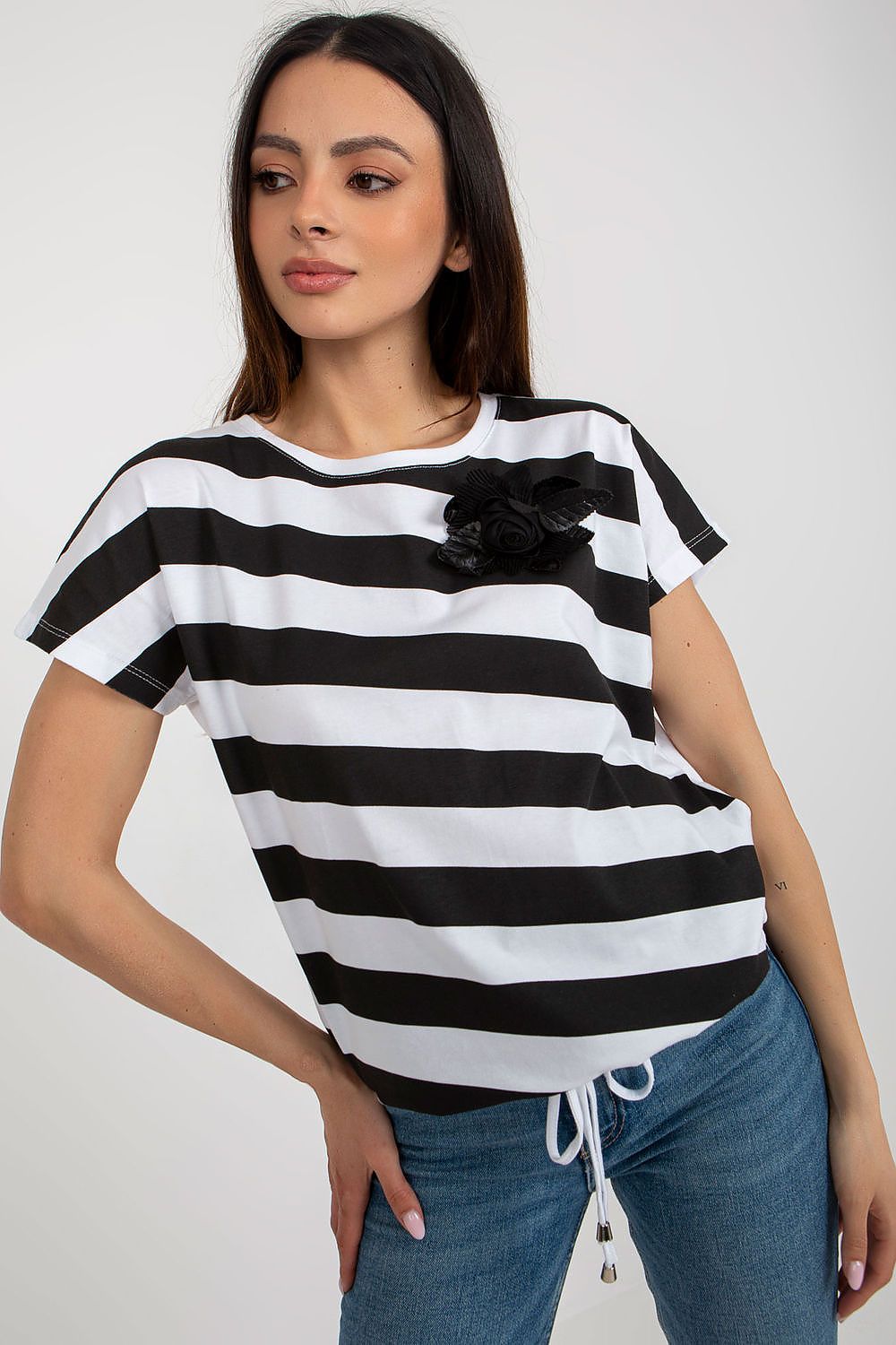 Chic floral brooch accent on a colourful striped women's blouse by Relevance, perfect for elegant occasions.