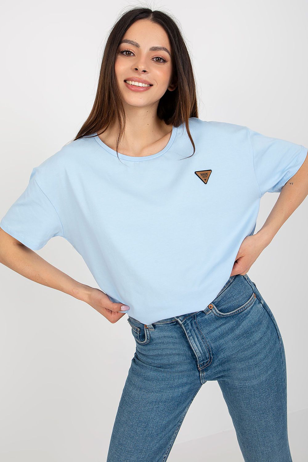 Close-up detail of the decorative patch on the Relevance women's short sleeve blouse made with 90% cotton and 10% spandex.