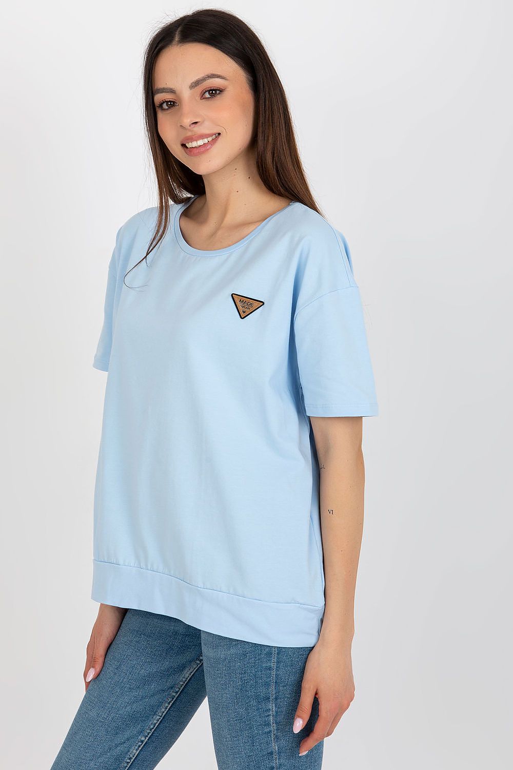 Model wearing an elegant short sleeve blouse by Relevance, showcasing its round neckline and luxurious cotton-spandex fabric blend.