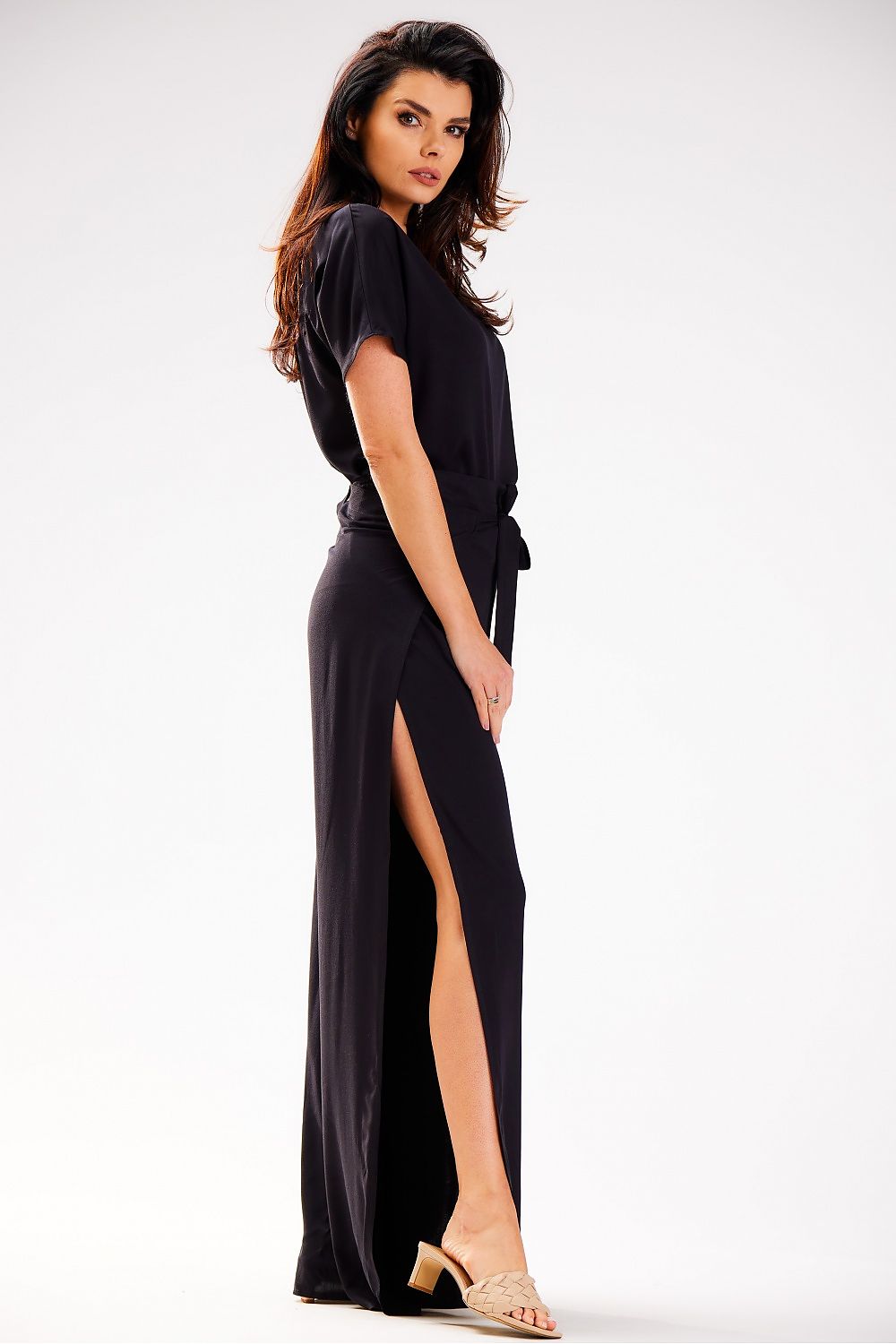 Elegant women’s Grecian tiered high-waisted trousers by awama, crafted in airy viscose, showcased in a chic outdoor setting.