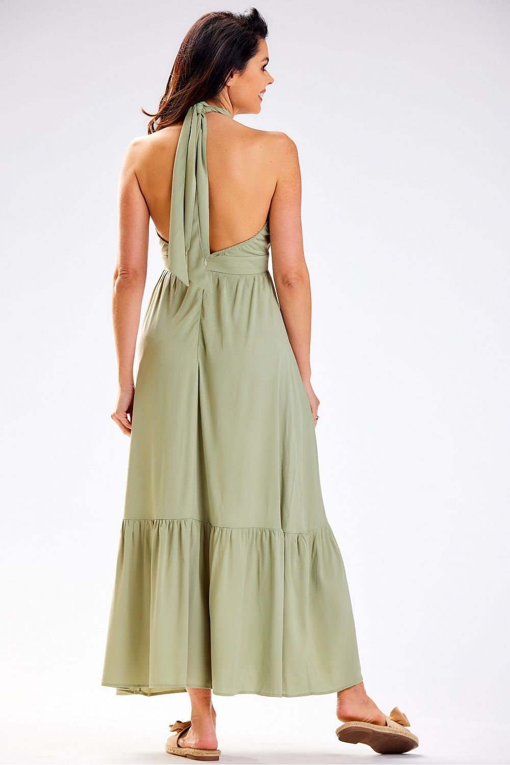Model wearing the Awama Daydress with an uncovered back, demonstrating its chic design and airy feel suitable for warm summer days.