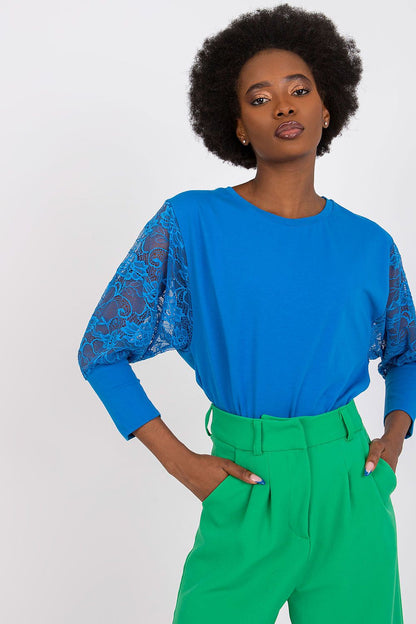 Stylish Rue Paris blouse with intricate lace detailing on 3/4 sleeves, perfect for sophisticated occasions.
