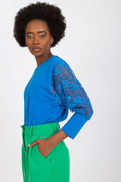 Chic Rue Paris cotton-spandex blouse showcasing exquisite lace sleeves, ideal for a refined wardrobe.