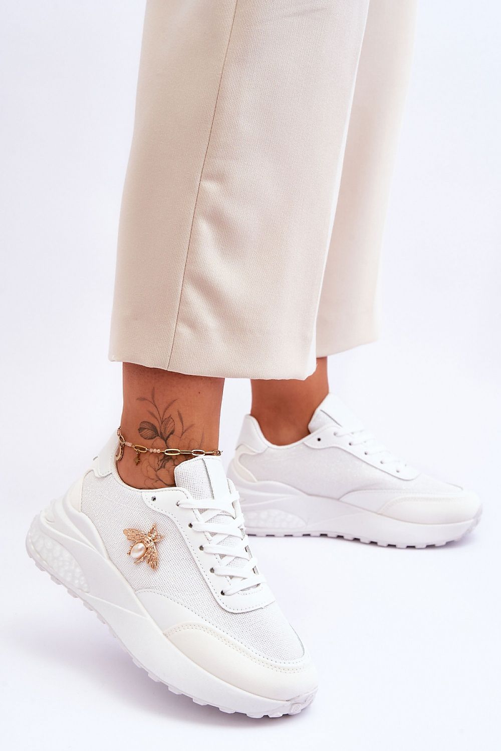 Elegant white sneakers with insect accents, made from eco-friendly materials, offering a chic and comfortable fit by Step in Style.