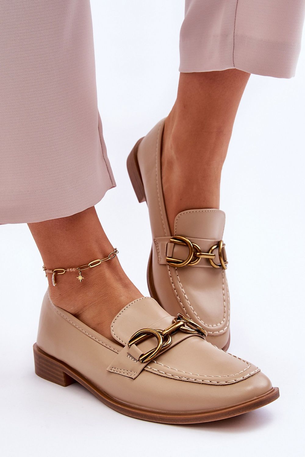 Chic women's slip-on moccasins from Step in Style made of eco-friendly leather with a decorative strap for a sophisticated look.