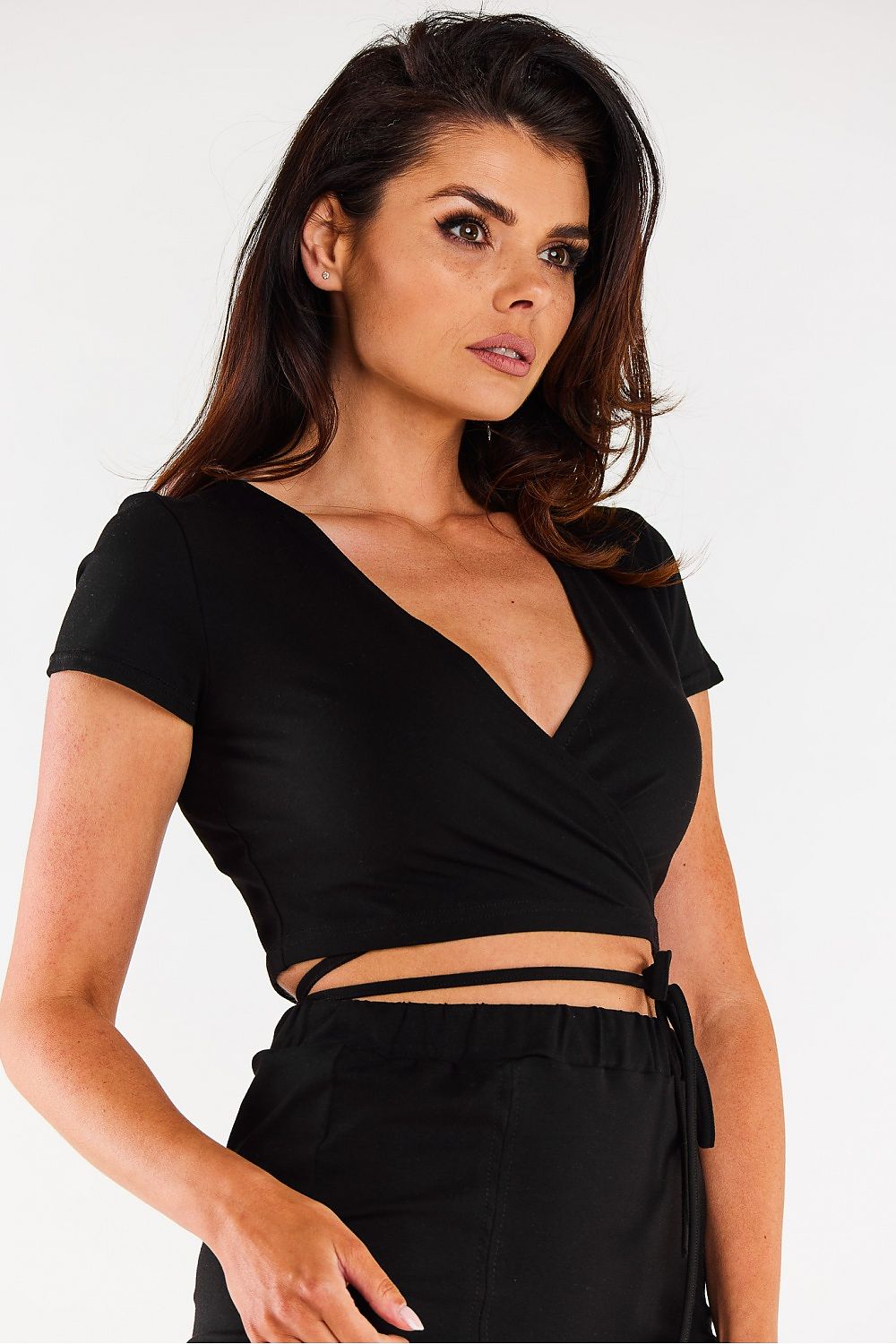 Model wearing the Infinite You Luxury Short Sleeve Crop Blouse, highlighting its versatile tied design at the front.