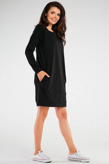 Model wearing the Infinite You elegant long sleeve daydress, styled for a sophisticated and fashionable look, emphasizing the relaxed fit and premium quality.