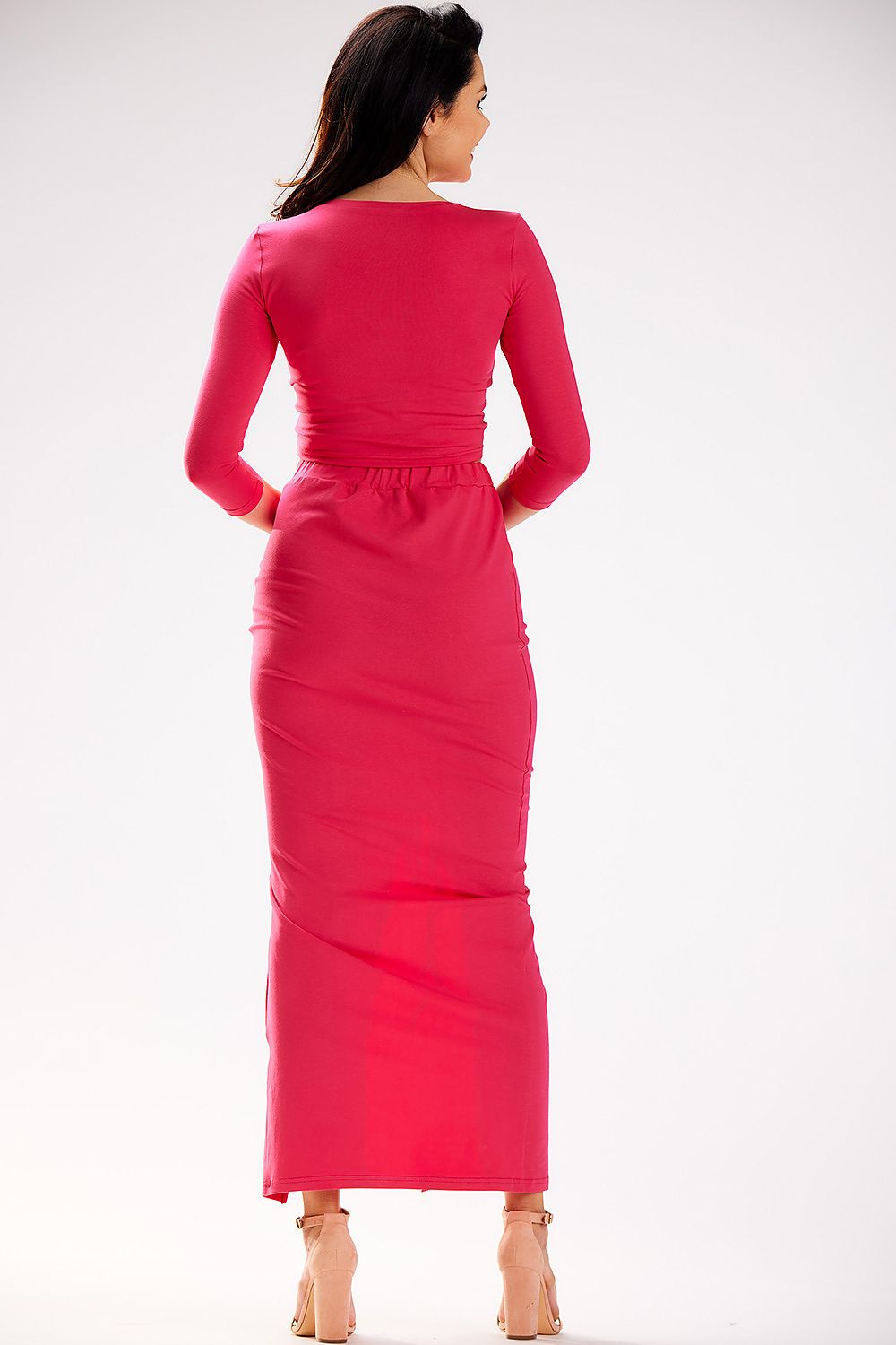 Model wearing Infinite You's graceful maxi skirt with slit, highlighting its flattering fit and luxurious feel in a beautiful fashion setting.