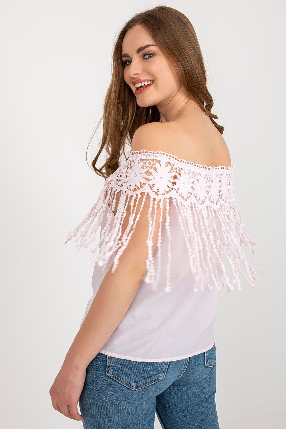 Elegant summer blouse by AT displayed on a mannequin, featuring decorative tassels and a sophisticated neckline for a chic summer aesthetic.