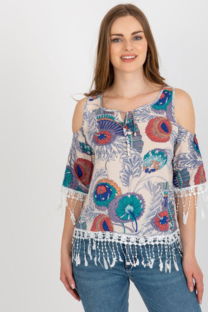 Stylish close-up of AT's luxury summer blouse, showcasing intricate print and tassel detailing on 3/4 sleeves and round neckline.