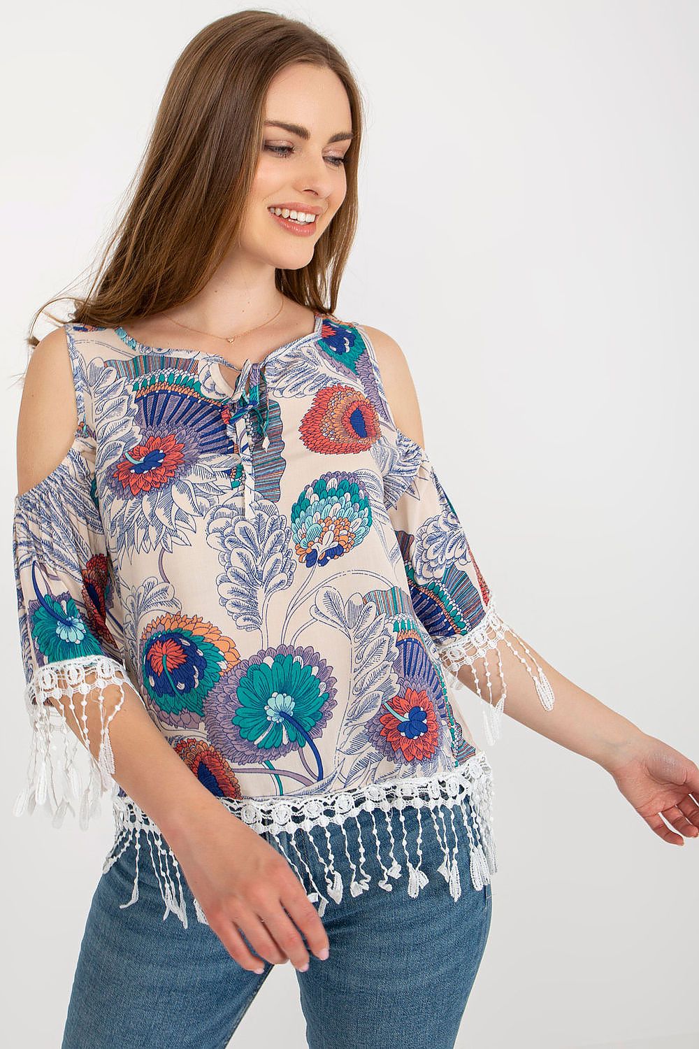 Elegant model wearing AT's luxury printed summer blouse with 3/4 sleeves, highlighting the vibrant fabric and decorative tassels.