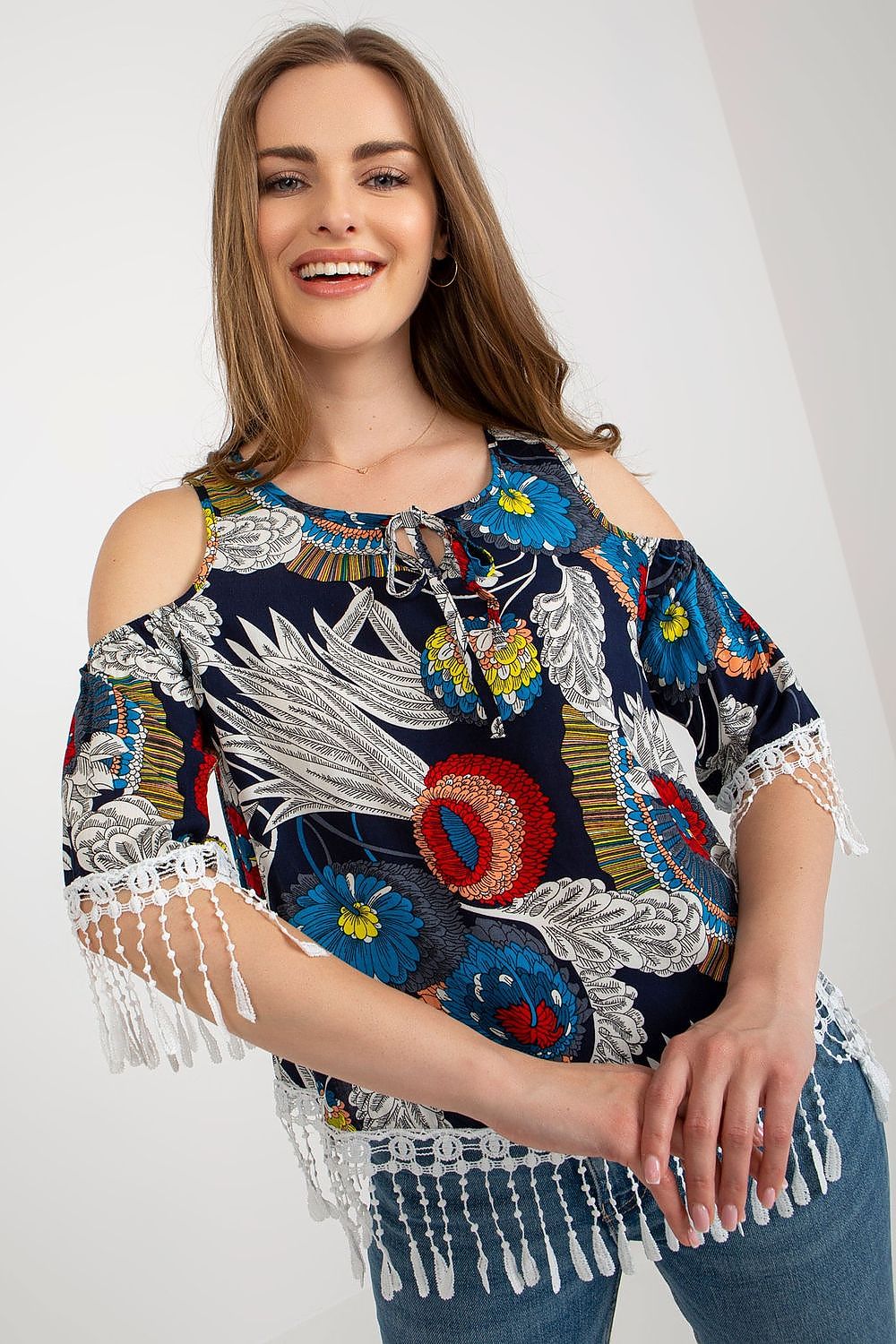 Chic luxury summer blouse by AT displayed on a model, highlighting feminine tassels and a modern printed design.