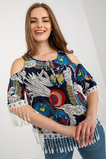 Chic luxury summer blouse by AT displayed on a model, highlighting feminine tassels and a modern printed design.