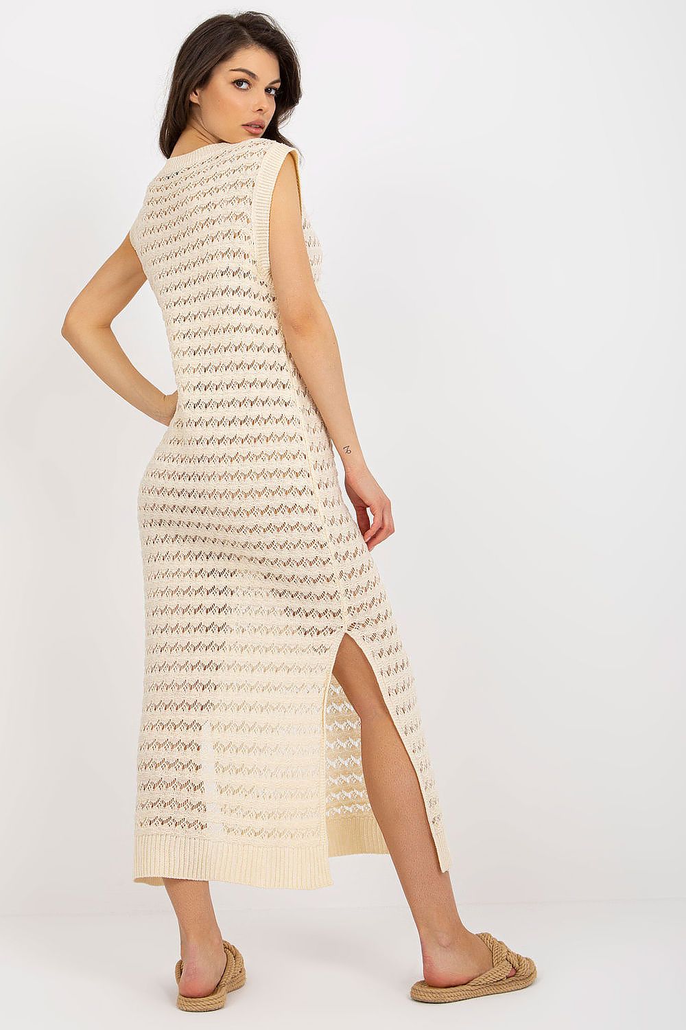 Luxury openwork long knit beach dress by Badu featuring decorative side slits, perfect for stylish beach outings.