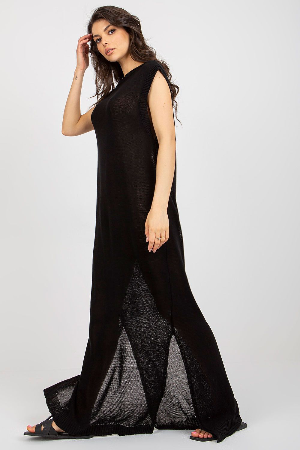 Elegant close-up of the side slits on Badu's luxury long knit beach dress, perfect for a fashionable summer ensemble.