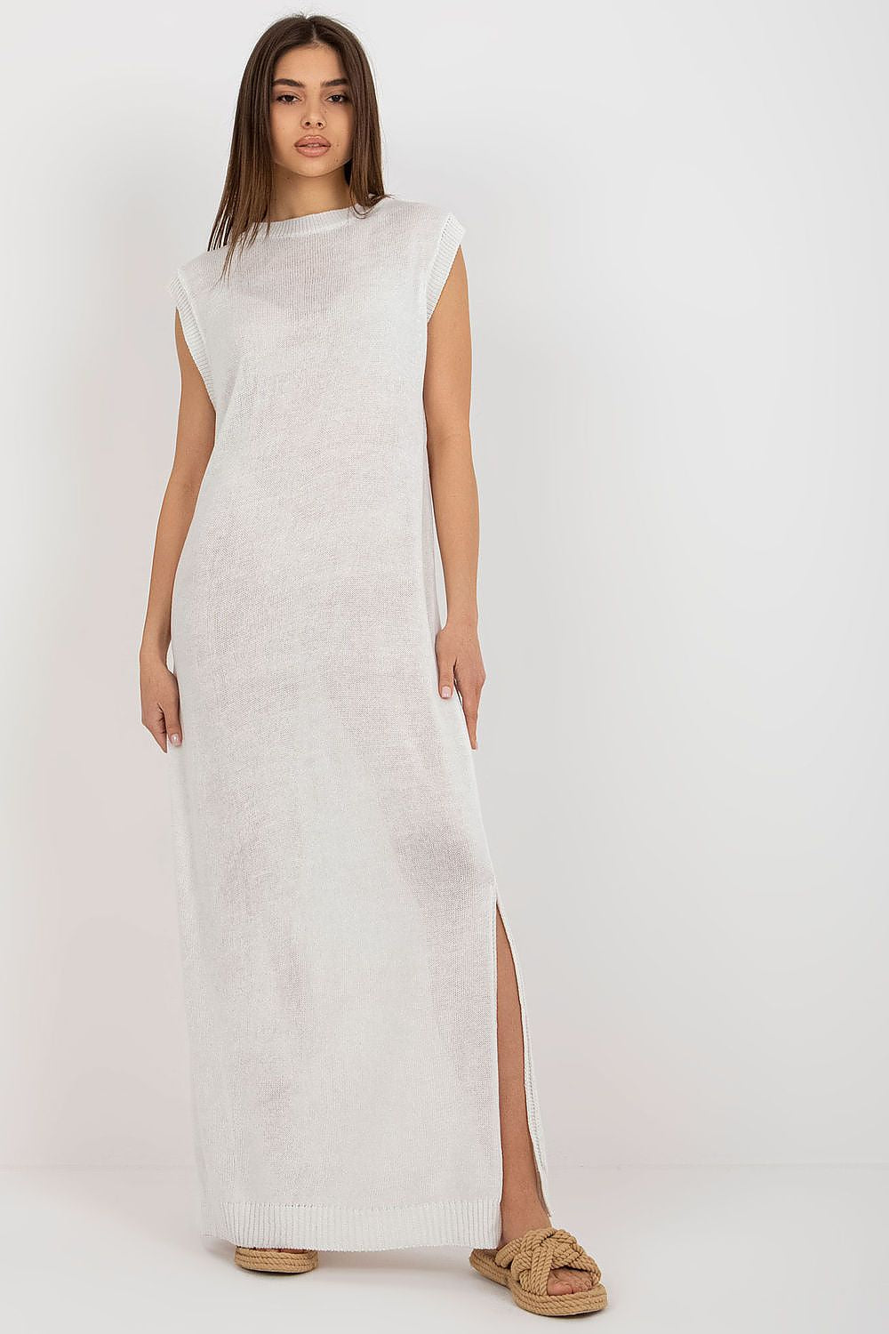 Stylish model wearing the luxury long knit beach dress by Badu, highlighting its sleeveless design and summer appeal.