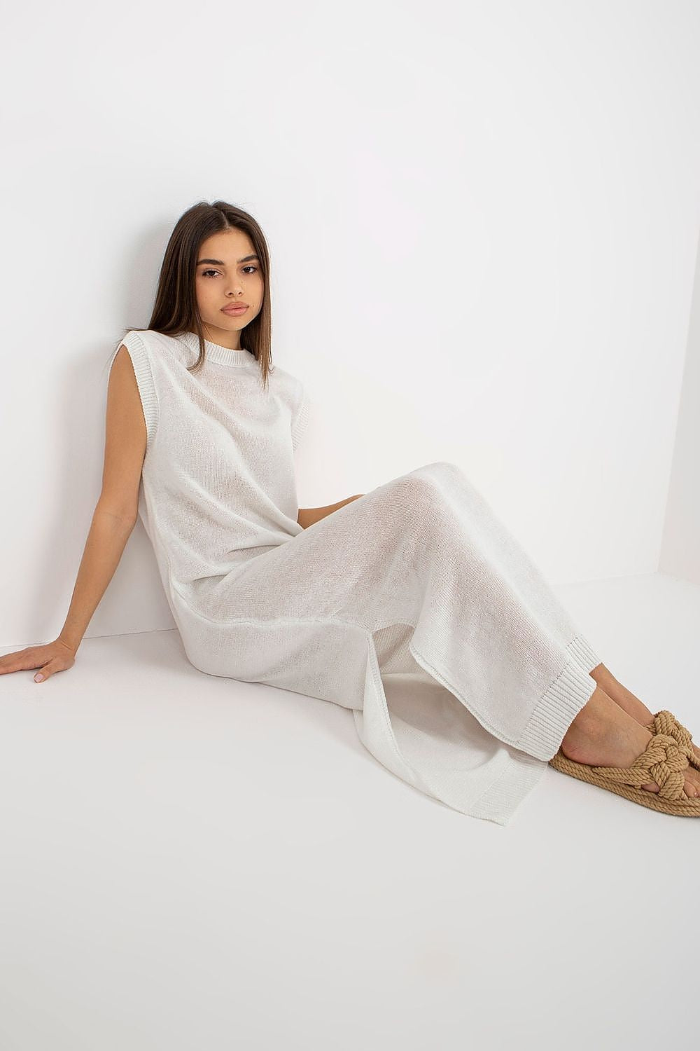 Detail view of the luxurious fabric and slits of the long knit beach dress by Badu, designed for elegant summer wear.